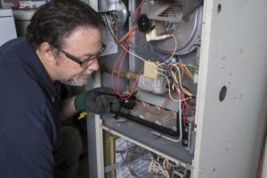 HVAC Technician inspecting a furnace