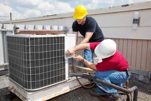 HVAC Contractors, two men working on an air conditioner